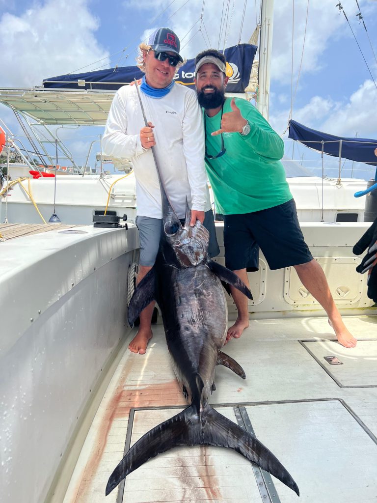 Zwei Angler mit einem Schwertfisch auf dem Deck am Steg in Kralendijk, Bonaire